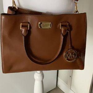 MICHAEL KORS  medium brown color in GREAT condition with strap only used twice.